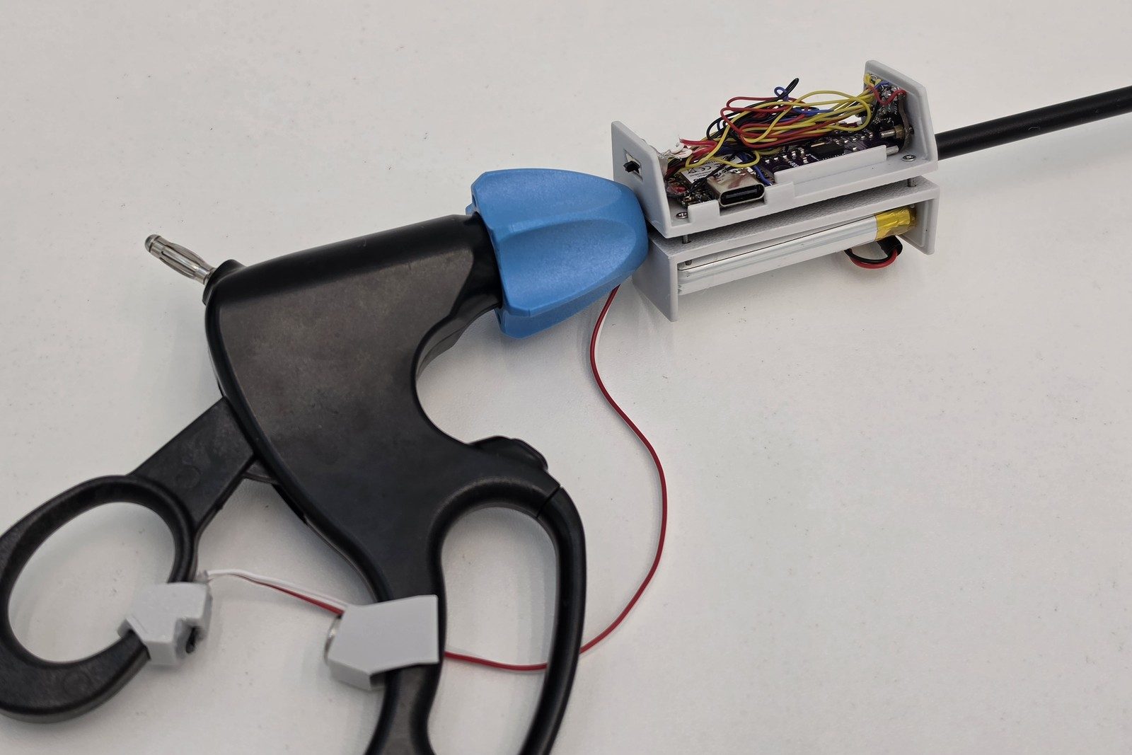 SurgiLogger with its enclosure open, showing the microcontroller, sensors and battery